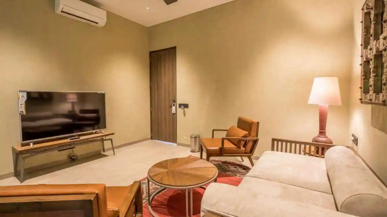 TV room with comfortable seating in Advait bungalow