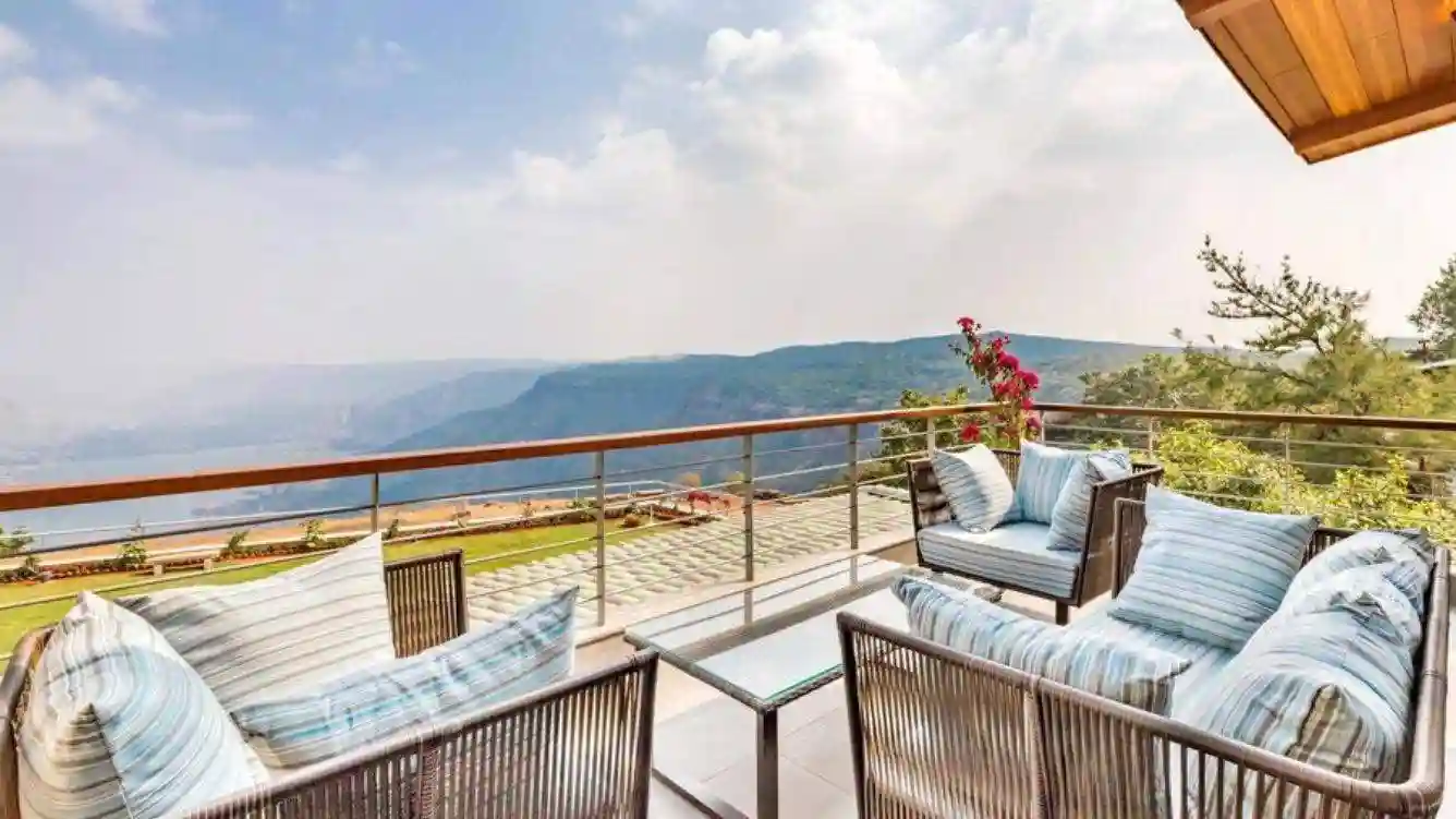 Private lawn area with outdoor seating at Advait bungalow